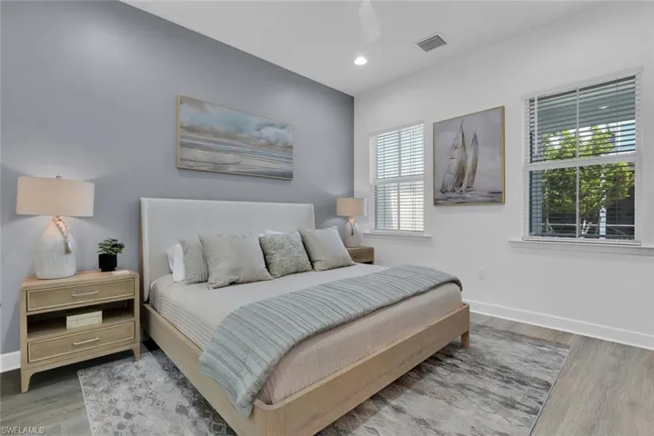 Bedroom with visible vents, baseboards, recessed lighting, and wood finished floors