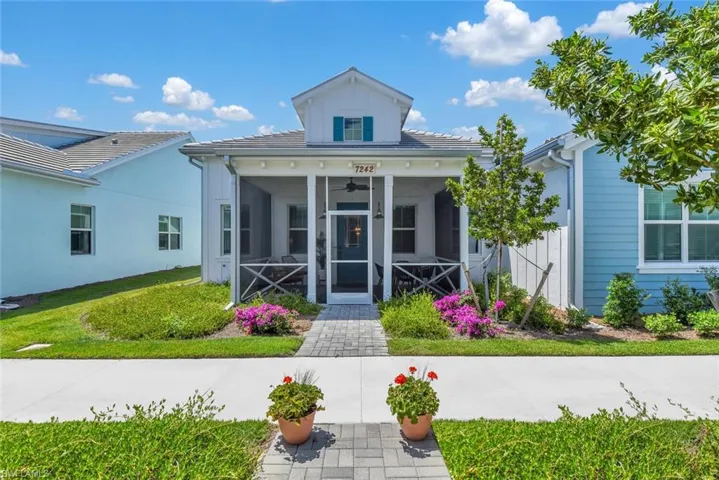 View of front of home featuring a sunroom and a front lawn