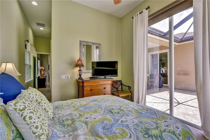 Sliding glass doors opening to a screened patio with a tiled floor