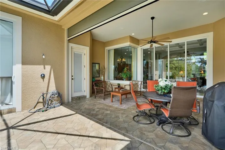 Covered outdoor patio featuring extensive paver flooring