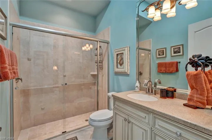 Walk-in shower with tiled walls and glass enclosure