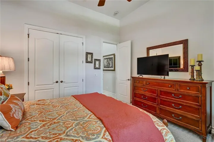 Bedroom featuring neutral wall colors, light-colored carpeting, and a ceiling fan