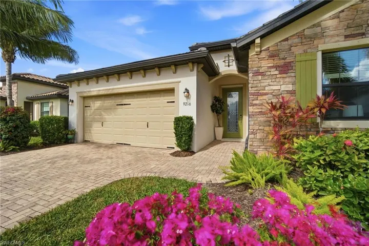 Charming exterior showcasing stone accents, tile roof, and lush greenery that enhance the home’s welcoming curb appeal