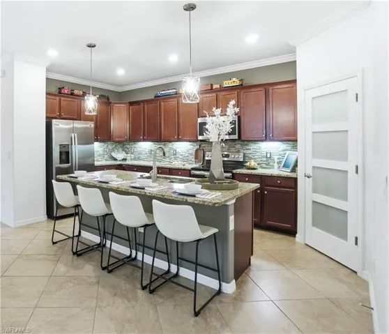 A large central island serves as functional work space as well as an additional dining area