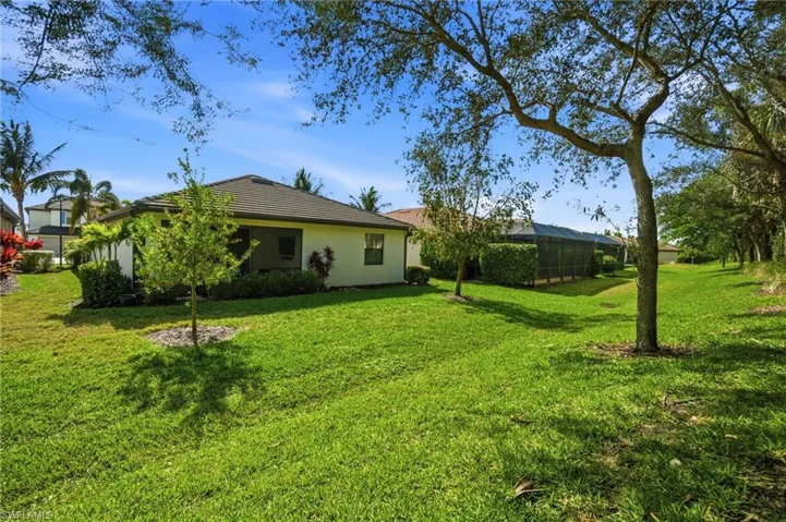 Peaceful outdoor setting with mature landscaping and room to enjoy the Florida lifestyle.