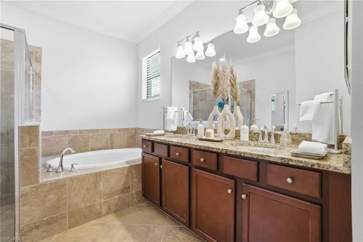 Primary bath offering dual vanities, walk-in shower, and a relaxing spa-like feel.