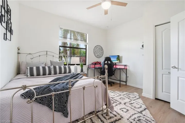 Light-filled guest bedroom with ample closet space and neutral finishes.