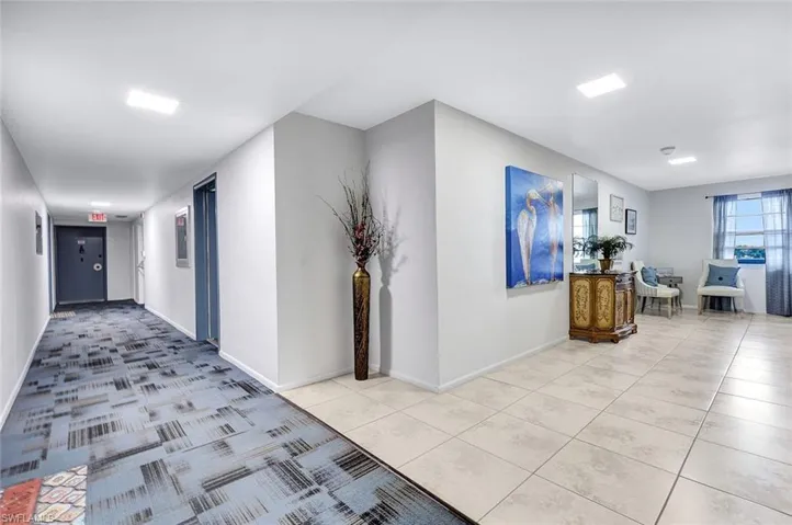 Hall featuring light tile patterned floors