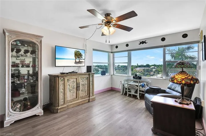 Sitting room featuring wood-type flooring and ceiling fan