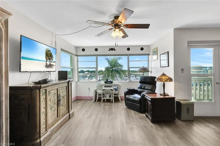 Sitting room featuring ceiling fan and wood-type flooring