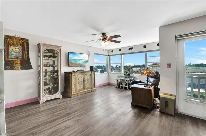 Living room featuring dark hardwood / wood-style floors and ceiling fan