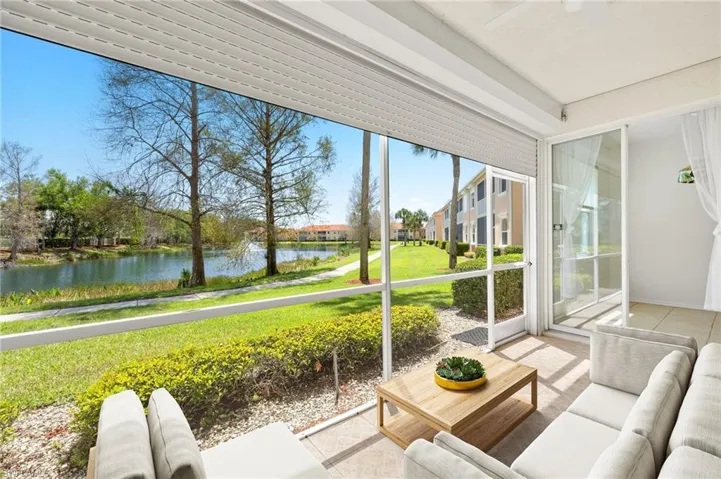 Tiled lanai overlooks lake and is surrounded by sliders