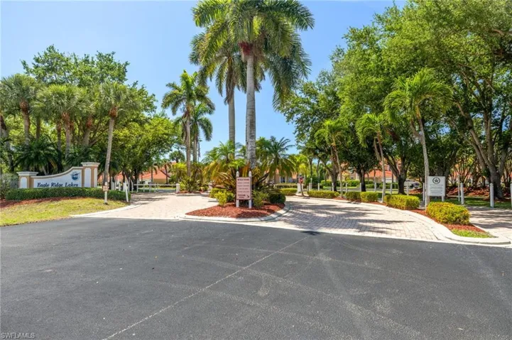 Lush tropical landscaping at the entrance with gate for residents and one for guests.