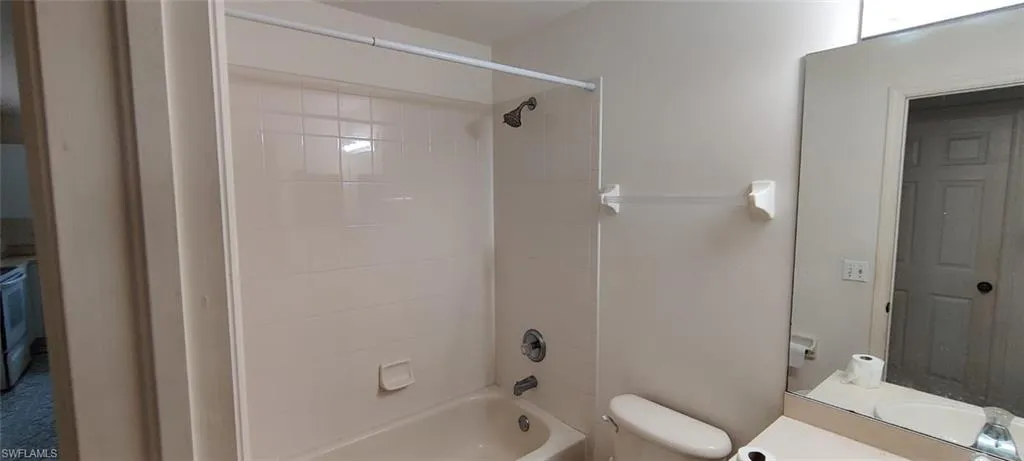 Full bathroom with vanity, toilet, and tiled shower / bath combo