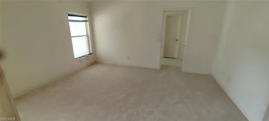 Unfurnished room with light carpet