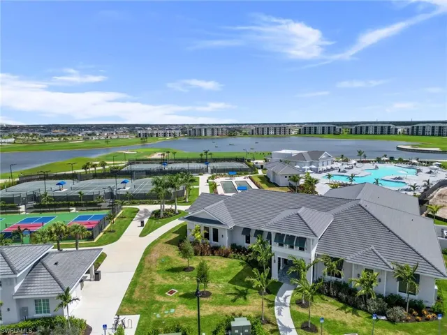 Birds eye view of property with a water view