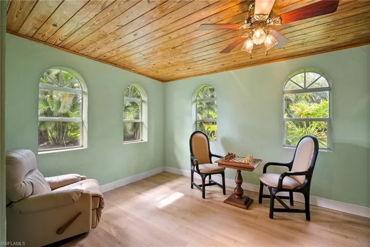 Sitting room featuring ceiling fan, wooden ceiling, and light hardwood / wood-style flooring