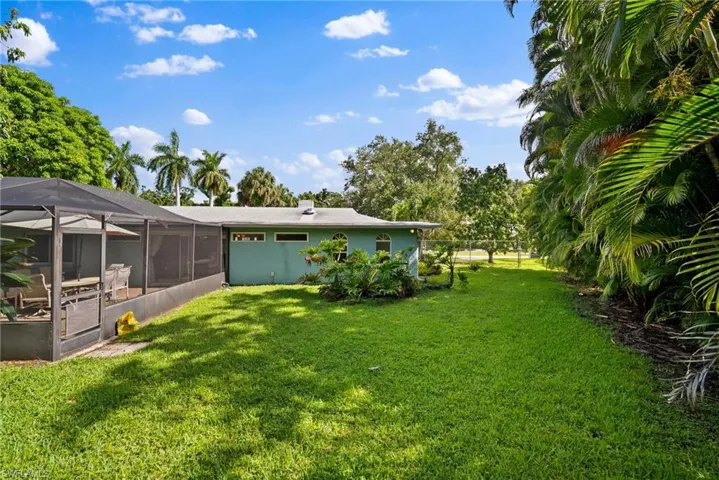 View of yard featuring glass enclosure