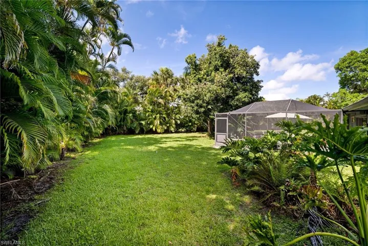 View of yard with glass enclosure