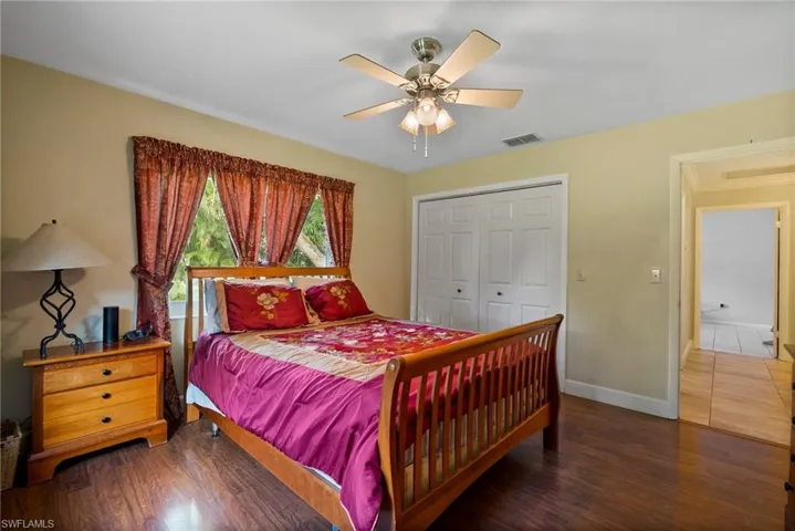 Bedroom featuring ceiling fan, hardwood / wood-style flooring, and a closet