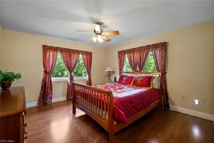 Bedroom with ceiling fan and hardwood / wood-style floors