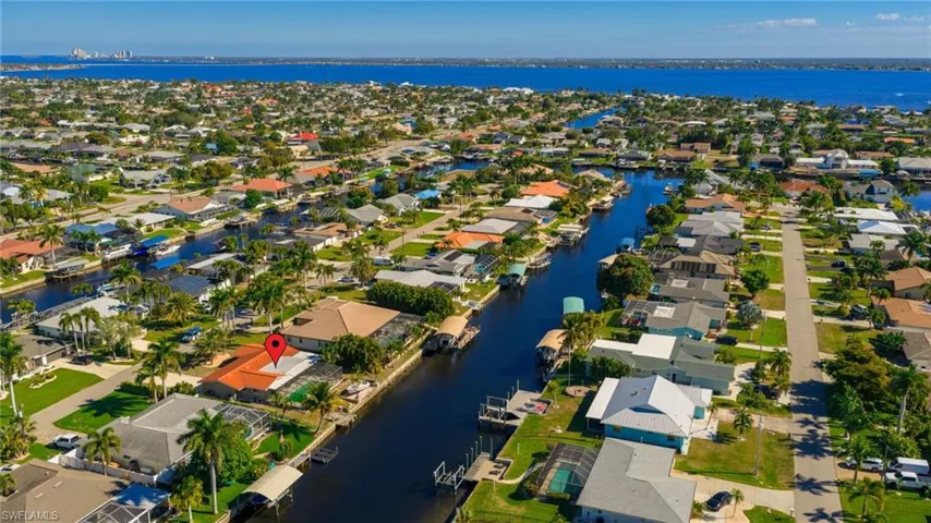 Aerial overview of property's location featuring a large body of water and nearby suburban area