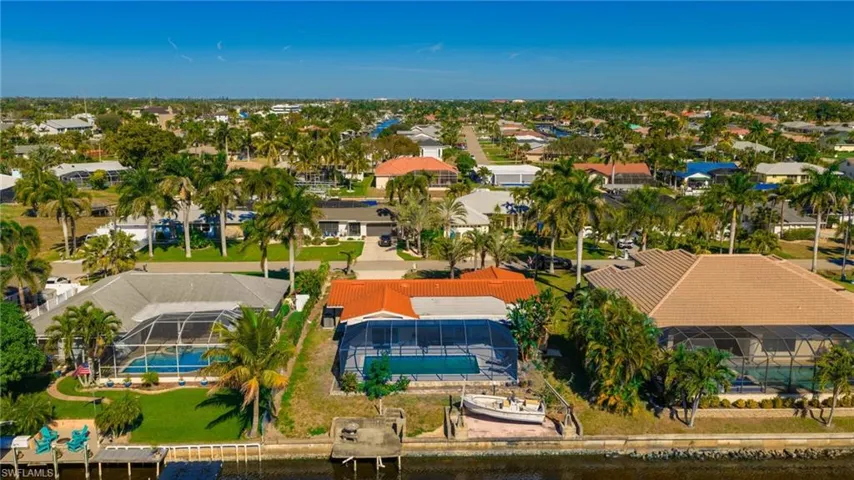 Aerial perspective of suburban area featuring a pool area