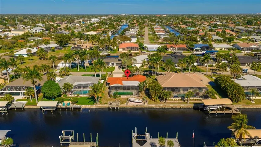 Aerial overview of property's location with a large body of water and nearby suburban area