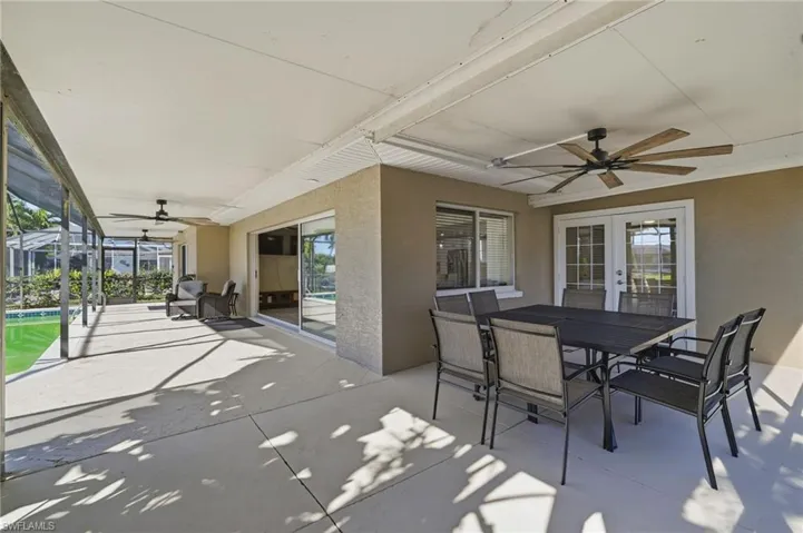 View of patio / terrace featuring ceiling fan, outdoor dining area, french doors, an outdoor pool, and a sunroom