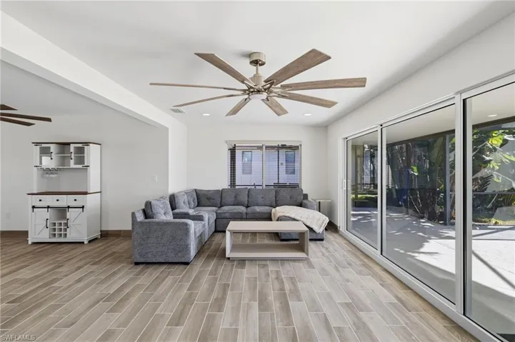 Living area with a ceiling fan, wood finish floors, and recessed lighting