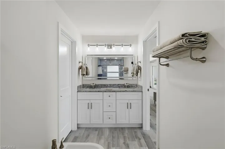 Bathroom featuring double vanity, a bidet, and wood tiled floors