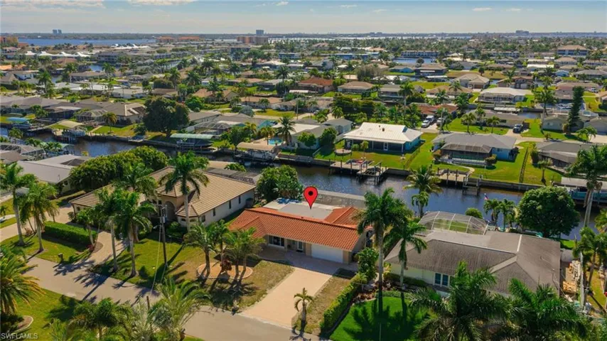 Aerial view of residential area featuring a nearby body of water