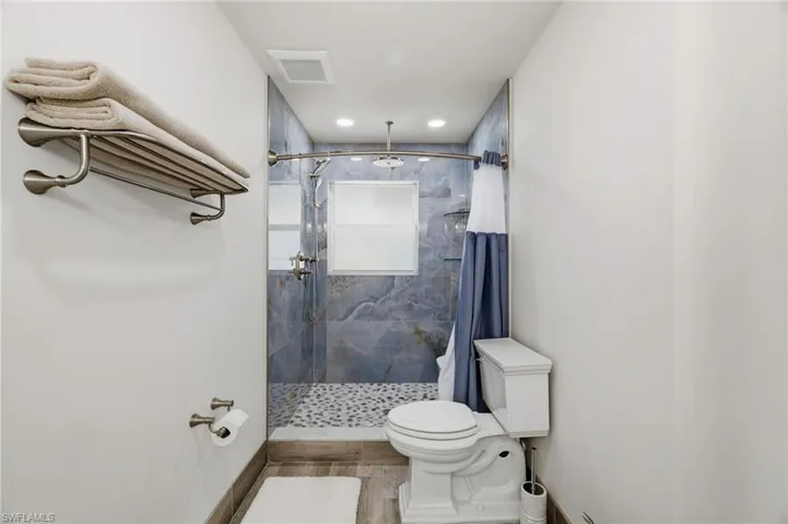 Bathroom featuring a shower stall and recessed lighting