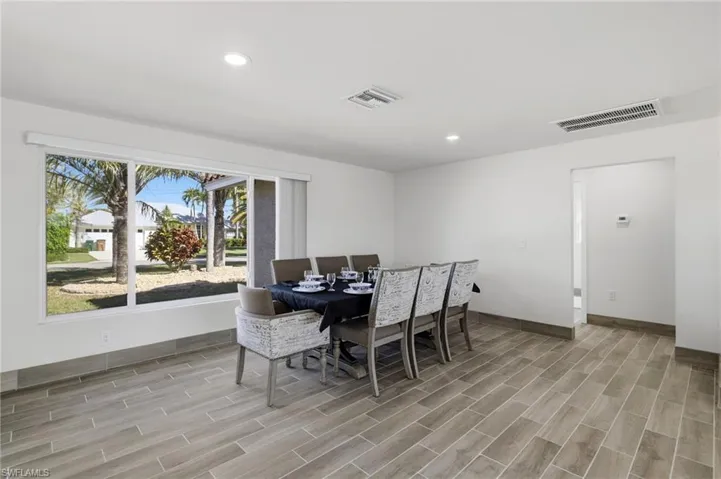Dining room with wood tiled floors and recessed lighting