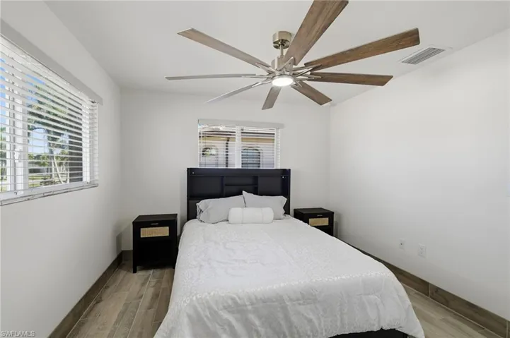 Bedroom featuring wood finish floors and a ceiling fan