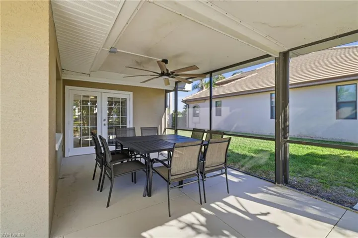 Sunroom / solarium featuring outdoor dining area, french doors, ceiling fan, and plenty of natural light