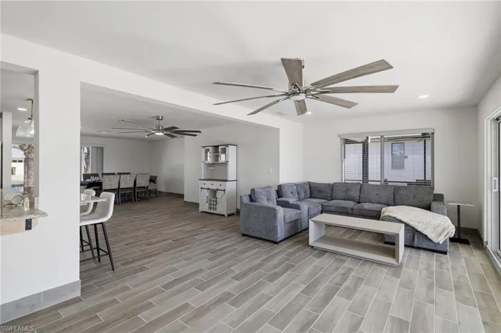 Living area with recessed lighting, wood finish floors, and ceiling fan