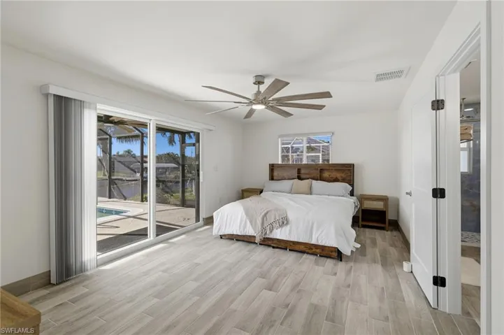 Bedroom featuring wood finish floors, access to outside, and ceiling fan