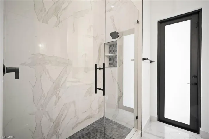 Bathroom with a shower with shower door