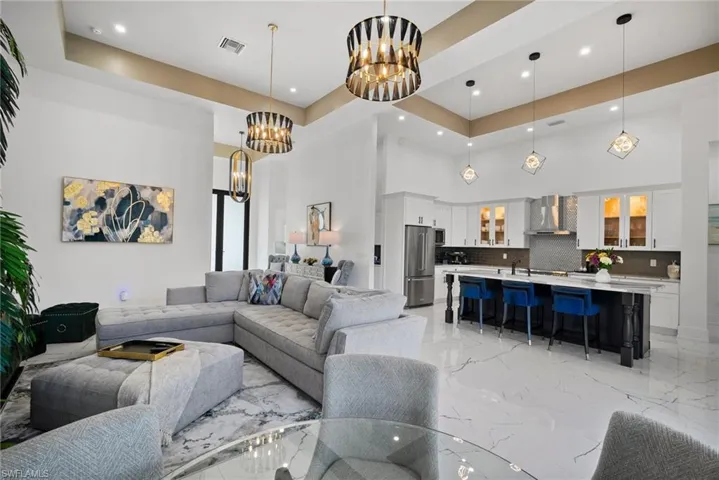 Living room with a high ceiling and a chandelier