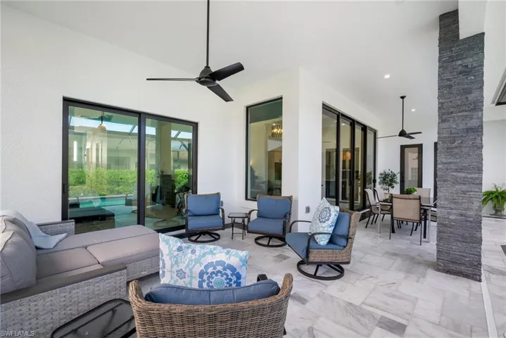 View of patio with an outdoor living space and ceiling fan