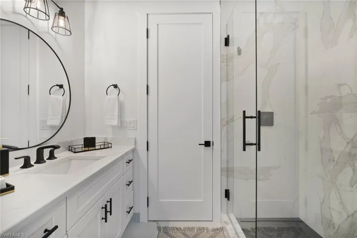 Bathroom featuring vanity and a shower with shower door