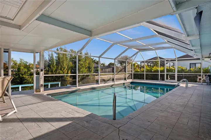 Swimming pool featuring a lanai, a patio area