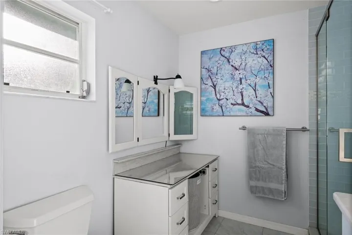 Bathroom featuring vanity, an enclosed shower