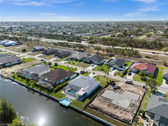 Aerial view of property's location with nearby suburban area