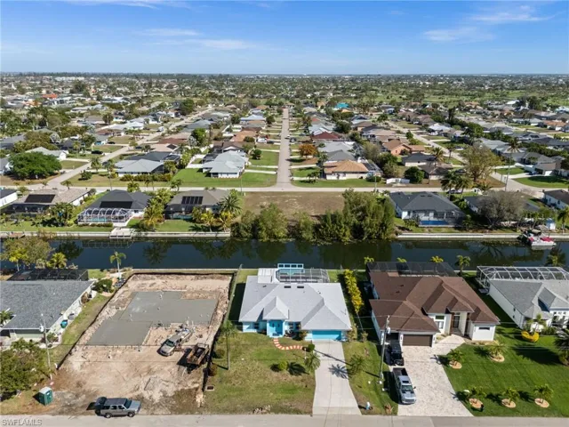 Aerial view of property's location featuring nearby suburban area on a canal