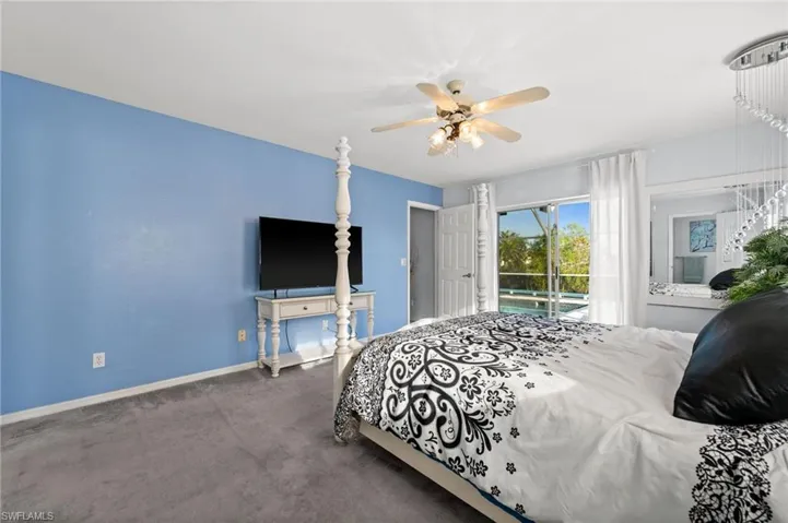 Bedroom with access to outside, and a ceiling fan