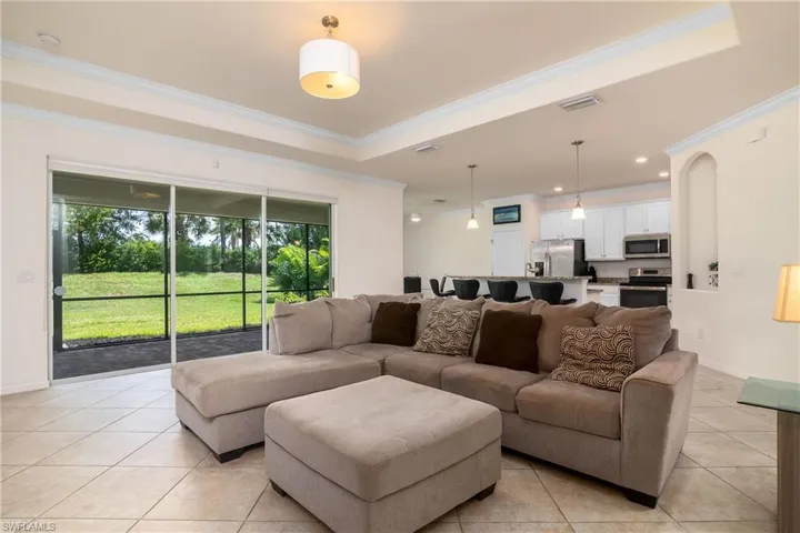 Tiled living room with a raised ceiling and ornamental molding