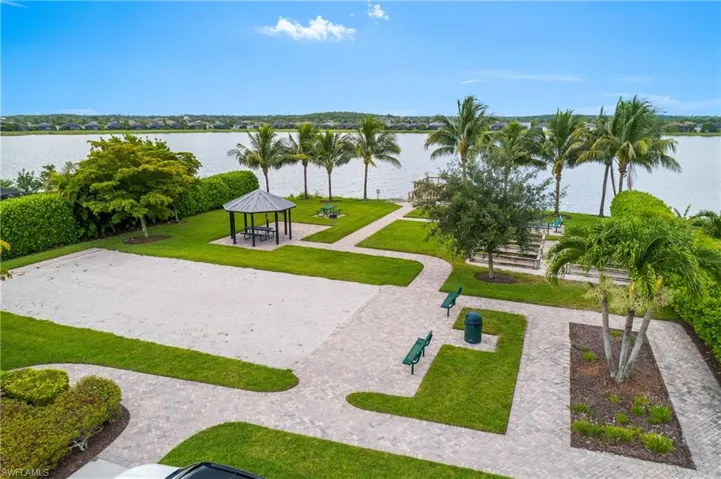 View of home's community with a water view, a lawn, and a gazebo
