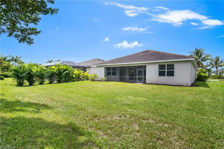 Rear view of house with a yard